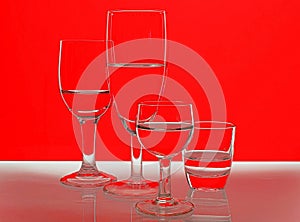 Glasses in front of a red and white background