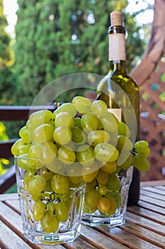 Glasses full of grapes and a bottle of wine