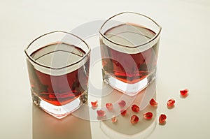 Glasses of garnet juice and grain/glasses of garnet juice and grain on a on white marble