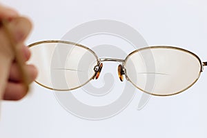 Glasses in a gold frame with diopters in hand