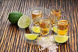 Glasses gold tequila with green lime o