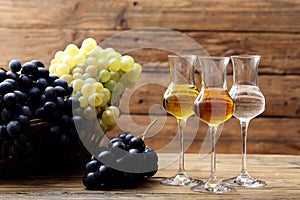 Glasses of grappa on rustic table