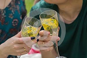 Glasses in the hands of people, couple holding glasses