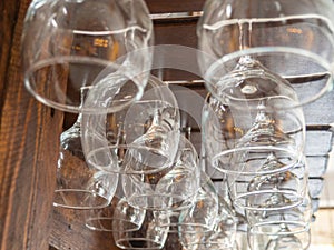 Glasses hang over the bar counter. The glasses are turned upside down. restaurant interior. Concept of drinking alcoholic