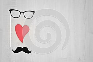 Glasses, heart, mustache on wooden background. Happy Father`s day background