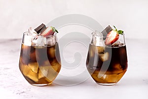 Glasses of Homemade Cold Brew Coffee to Drink for Breakfast Summer Beverage with Ice Cubes Decorated with Strawberry and Chocolate