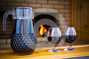 Glasses and a jar with wine standing in a row