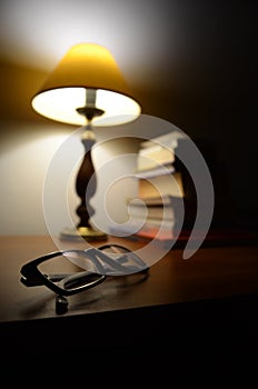 Glasses, lamp and books - homely atmosphere