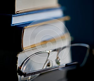 Glasses lie on a stack of books, science