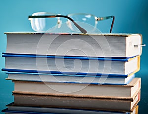 Glasses lie on a stack of books, science