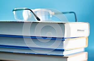 Glasses lie on a stack of books, science