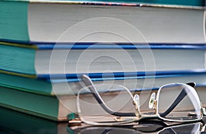 Glasses lie on a stack of books, science