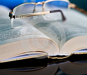 Glasses lie on a stack of books, science