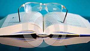 Glasses lie on a stack of books, science