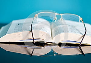 Glasses lie on a stack of books, science