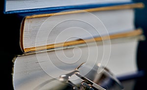 Glasses lie on a stack of books, science