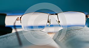Glasses lie on a stack of books, science