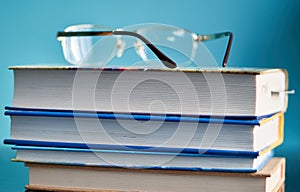 Glasses lie on a stack of books, science