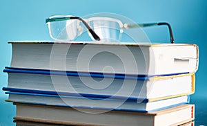 Glasses lie on a stack of books, science