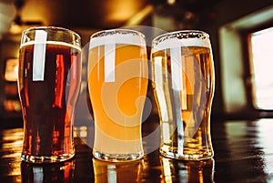 Glasses of light and dark beer on a pub background