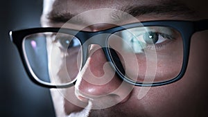 Glasses with light reflected from computer or smartphone screen.