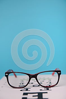 glasses lying on snellen test chart