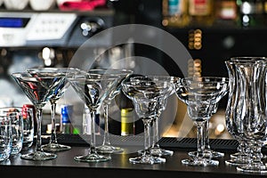 Glasses for a margarita, martini, grog and liqueur on a bar at r