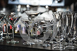 Glasses for a margarita, martini, grog and liqueur on a bar at r