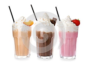 Glasses with milk shakes on white background