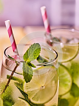 Glasses with mohito and straw.