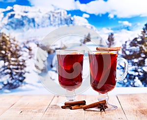 Glasses of mulled wine over winter landscape