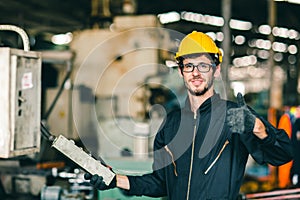 Glasses nerdy worker show thumb up happy working in factory, industrial engineer man enjoy to work operate the machine