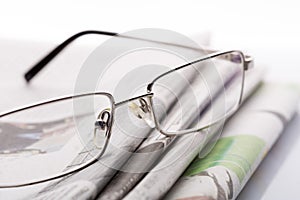 Glasses on the newspapers macro