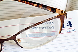 Glasses and Newspapers on the table surface.