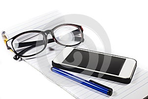 Glasses notebook pen telephone