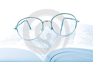 Glasses on the open book