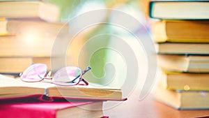 Glasses and open book. best books home library background. read vintage books in a row. college library table