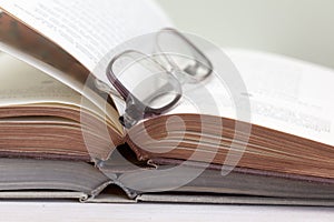 Glasses and open books on the table