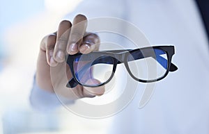 Glasses, optometry and hands of a doctor for vision, eyesight checkup and giving prescription eyewear. Recommendation