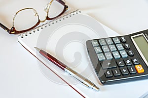 Glasses,Pen,Calculator,And Notepad