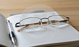 Glasses and pen on diary