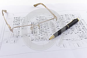 Glasses and pen lie on the engineering drawing