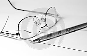 Glasses, pencil and graph