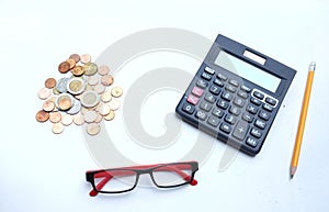 Top view a glasses,pencil, money, calculator and chart or graph on office desk table.Finance and business concept.