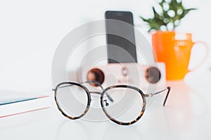 Glasses with phone and plant
