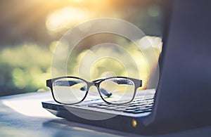 Glasses placed on the laptop in the library.