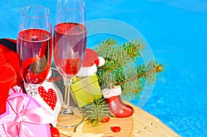 Glasses with red champagne and Christmas decor