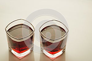 Glasses with red drink/glasses with red drink on a glossy marble background. Top view