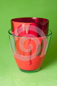 Glasses with red paint on a green background