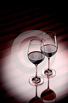 Glasses of red whine in an illumination